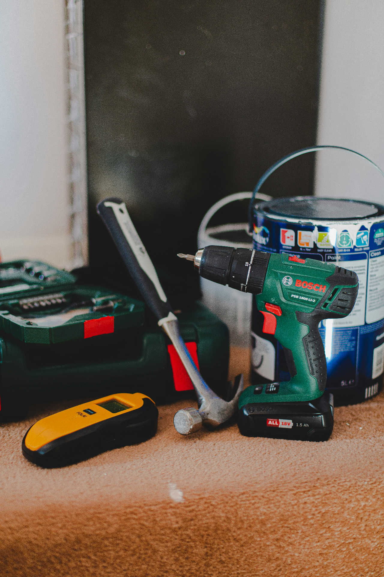 Maintenance tools including a drill, hammer and paint